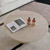 Round Japandi coffee table with beige travertine top and premium wood base